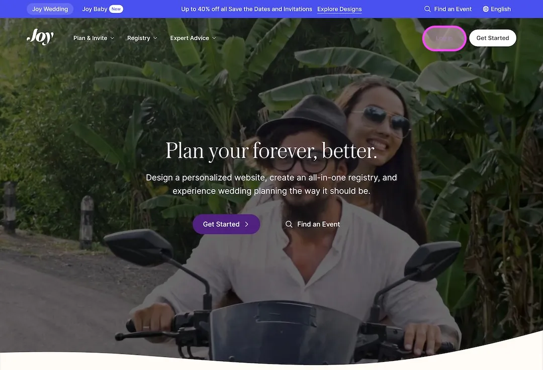 Joy login page with a smiling couple riding a motorcycle in front of green tropical plants