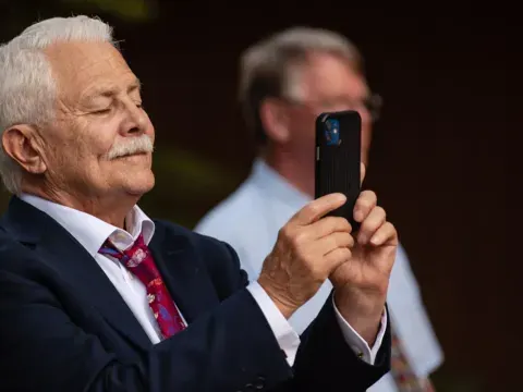 Wedding guest holding up a phone to record