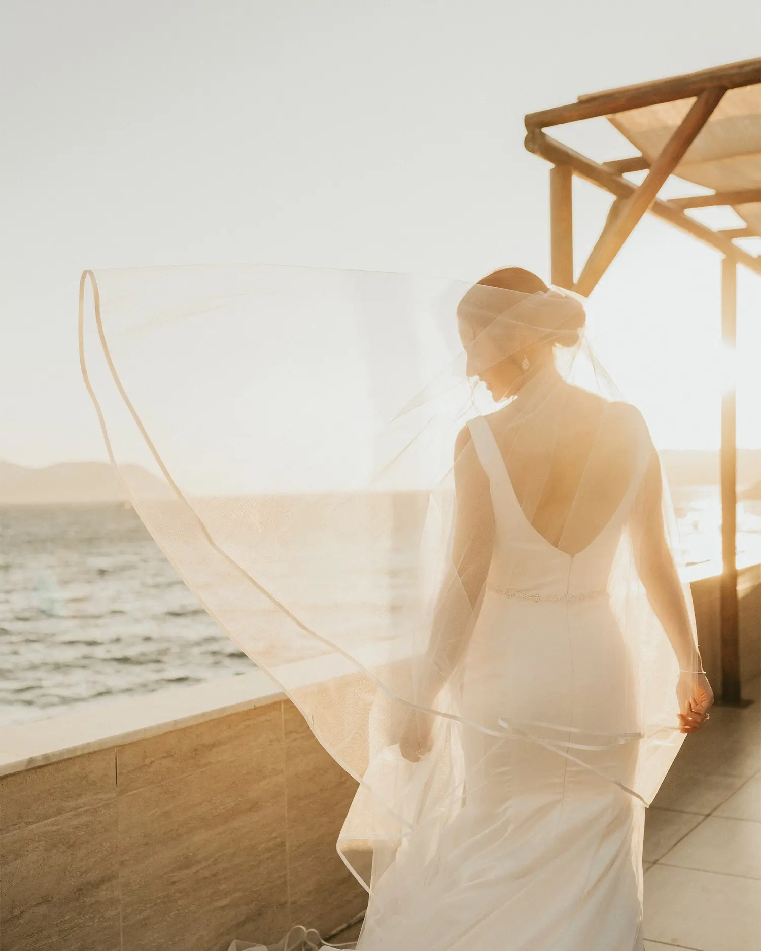 Bride walking outdoors in golden sunset light