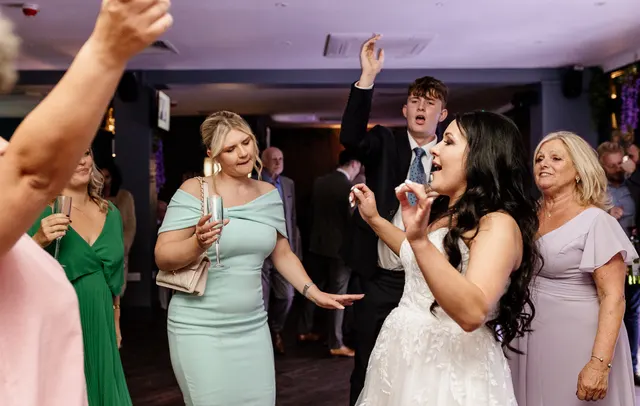 Bride dancing with guests on the wedding dance floor