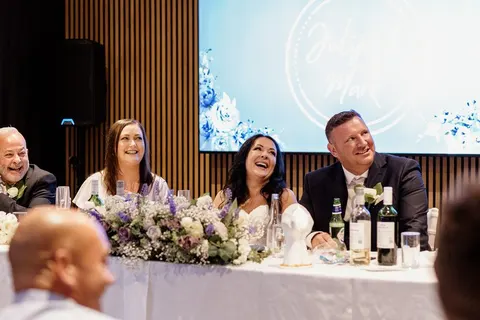 Bride and groom smiling during a toast