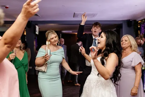 Bride dancing with guests, shared in the guestbook