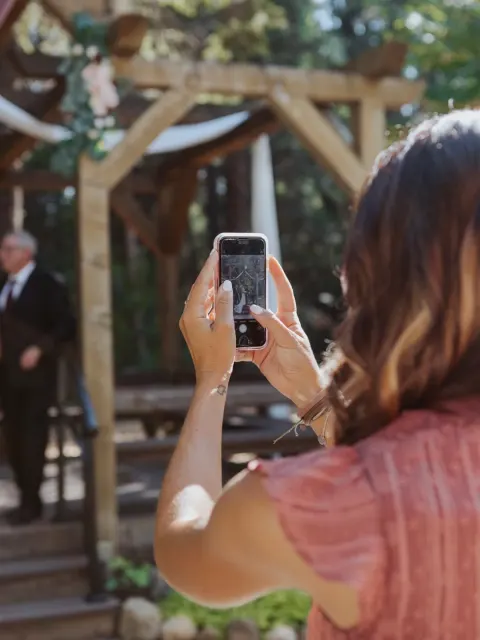 Guest capturing wedding memories