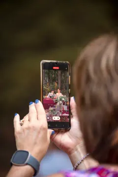 Mom taking a photo of the couple