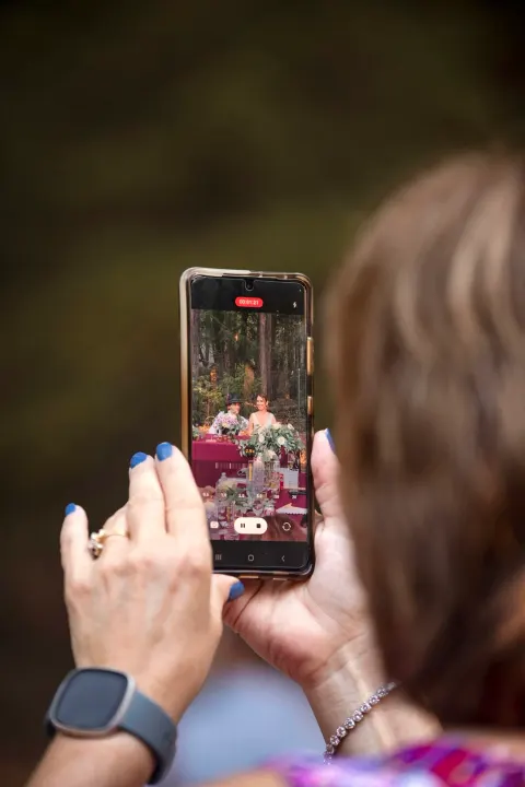 Mom taking a photo of the couple