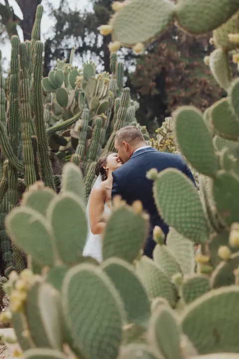 Groom kissing the bride in the desert